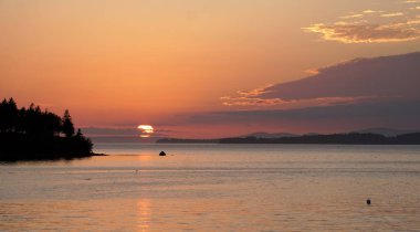 A breathtaking shot of the sunset across Penobscot Bay viewed from Northwest Harbor Deer Isle, Maine clipart
