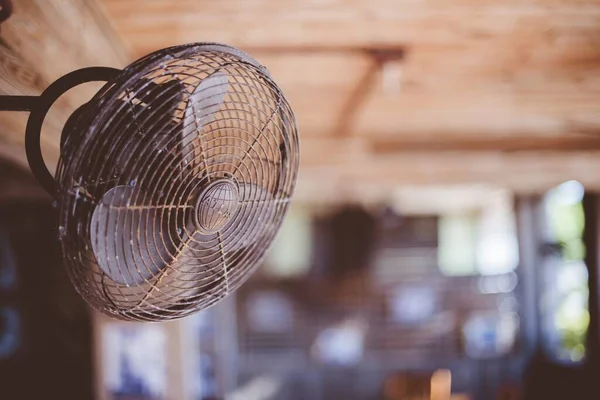 Closeup shot of an old russeted fan attached on the all with a blurred background — ストック写真