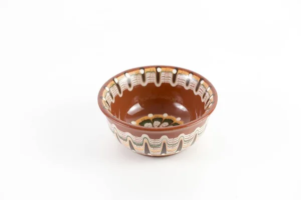 Foto de ángulo alto de un cuenco de cerámica marrón con hermosos patrones aislados sobre un fondo blanco — Foto de Stock