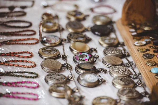 Closeup shot of old pocket watches on a white surface in the market — ストック写真