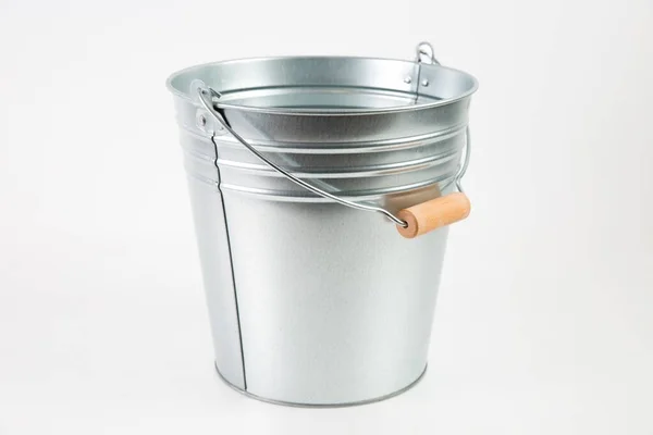 Silver empty bucket with a wooden holder isolated on a white background — ストック写真