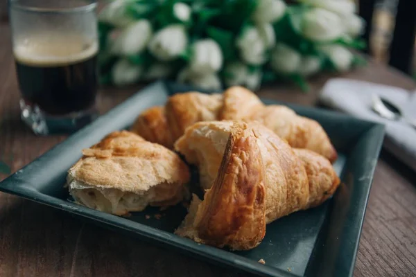 High angle closeup shot of bitten croissants on blurred background — Stock Photo, Image
