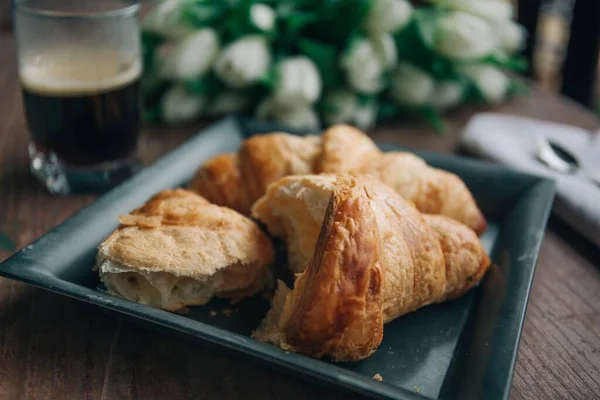 High angle closeup shot of bitten croissants on blurred background — ストック写真