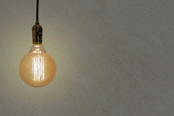 Vintage Glühbirne isoliert auf einem strukturierten Hintergrund - perfekt für einen Hintergrund — Stockfoto