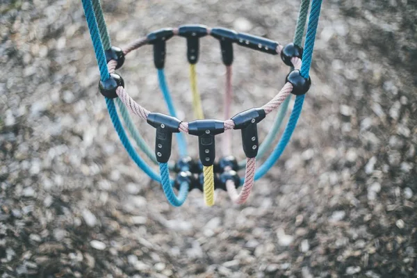 High angle shot of a colorful swing in a park with ta blurry background — Stock Photo, Image