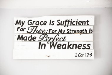 Closeup shot of a white wooden sign with a bible quote and a white background clipart