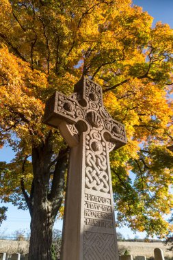 Cemetery Grave Stone Cross and Autumn Folliage clipart