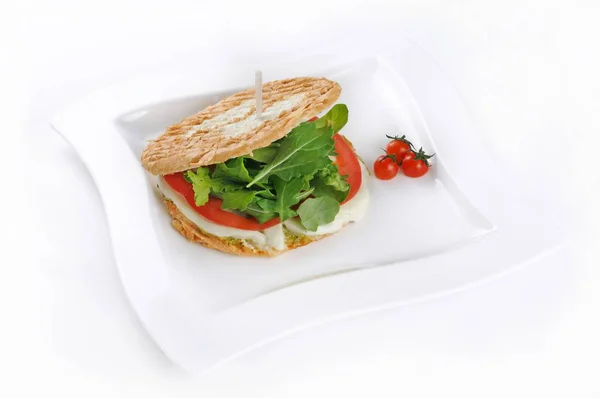 Isolated shot of a sandwich with tomatoes and mozzarella - perfect for a food blog or menu usage — Stock Photo, Image