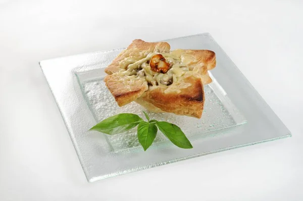 Isolated shot of a plate with puff pastry with mushrooms - perfect for a food blog or menu usage