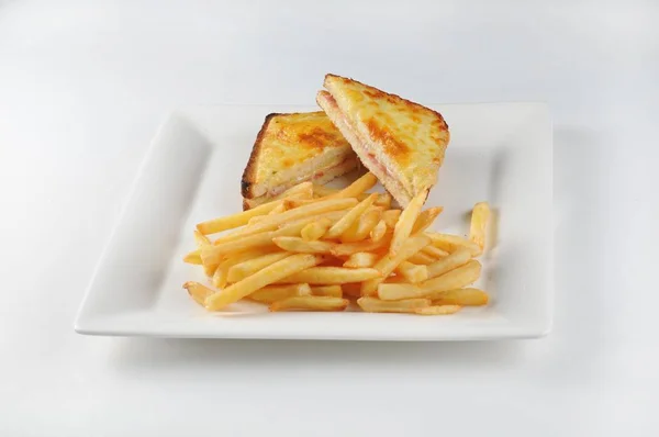 Isolated shot of Croque monsieur and french fries - perfect for a food blog or menu usage