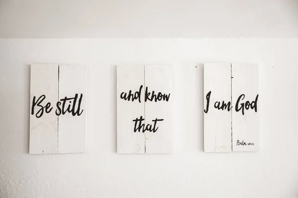 Closeup shot of white wooden sign with a bible quote written on it and a white background — Stock Photo, Image