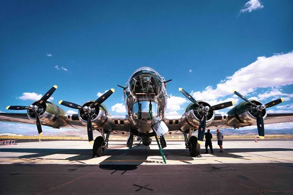 The exterior of a B-17 bomber plane from WWII in an airbase