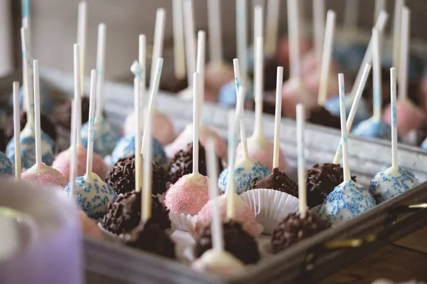 A closeup shot of chocolate cookie pops with a blurred background