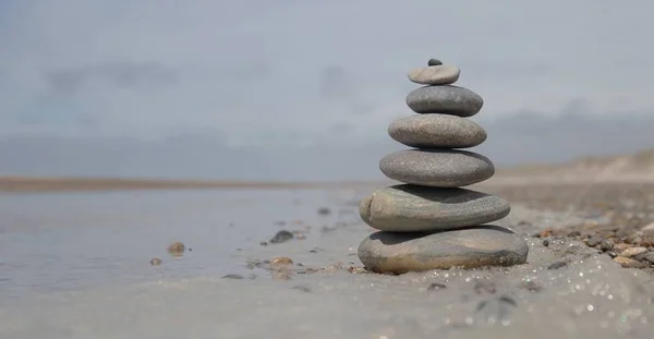 A beautiful shot of a stack of rocks on the beach - business stability concept