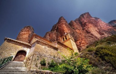 The Mallos de Riglos rock formations near a concrete building in Huesca, Spain clipart