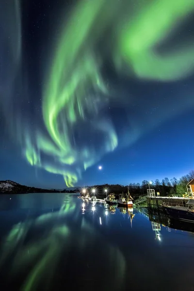 Vertical shot of the reflection of the colorful northern lights in the water