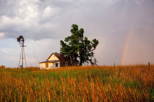 After a heavy thunder storm, a rainbow appears where an old farmhouse and windmill sit in Buffalo, Oklahoma.