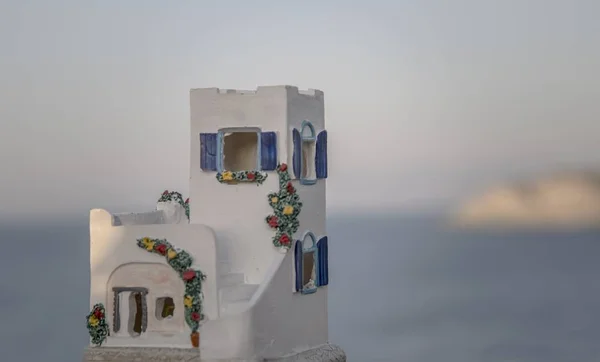 A closeup shot of a white castle figure on the beach on a blurred background