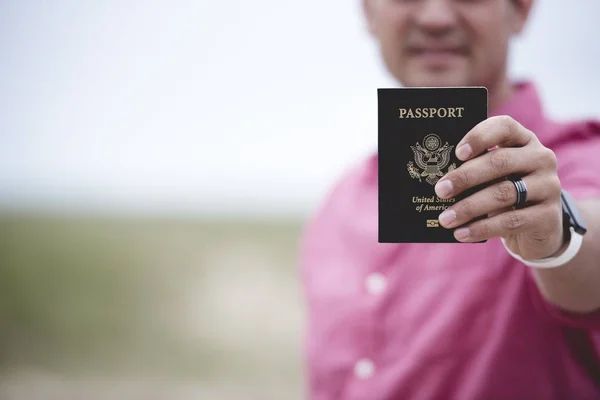 Closeup Shot Male Holding His Passport Camera Blurred Background — Stock Photo, Image