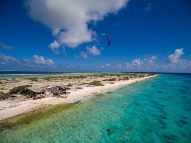 Beautiful shot of a brave person kitesurfing in Bonaire, Caribbean clipart