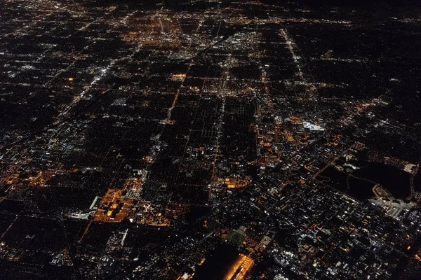 Légi felvétel egy kivilágított városképről sok épülettel éjszaka. — Stock Fotó