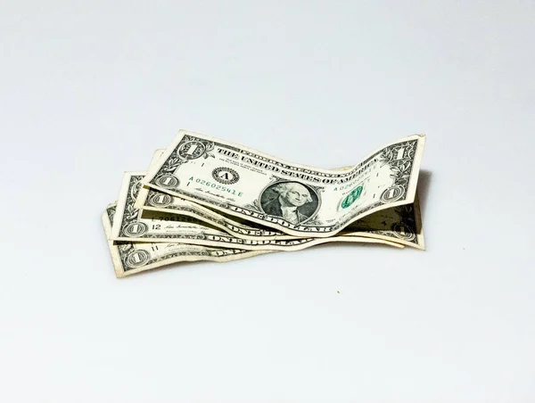 Fotografia isolada de algumas notas de um dólar num fundo branco — Fotografia de Stock