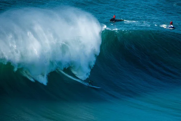 Surfař plující pěnivými vlnami Atlantského oceánu směrem ke břehu nacismu, Portugalsko — Stock fotografie