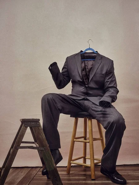 男性のような椅子に座っている男性のスーツの垂直ショット — ストック写真