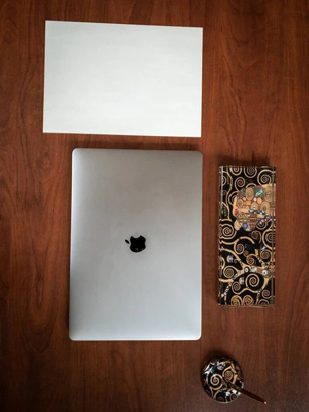 Вертикальний високий кут знімок Apple Macbook та інших предметів на дерев'яному офісному столі. — стокове фото