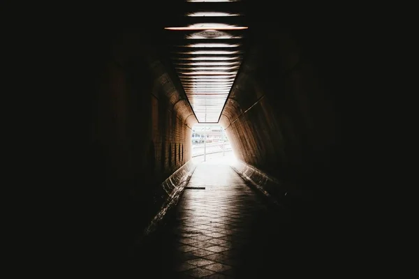 Bright light at the end of a paved underpass — Stockfoto