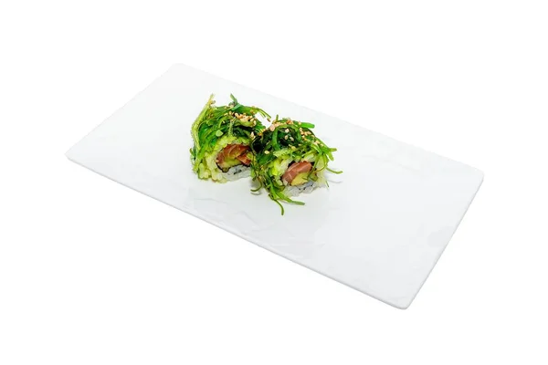 Two pieces of sushi rolls with fish and vegetables on a white tray isolated on a white background — Stock Photo, Image