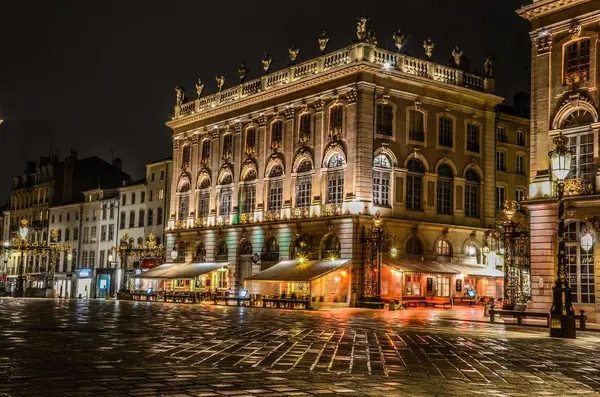 Schöne Aussicht auf die alten Gebäude auf den gepflasterten Straßen, die in der Nacht in Paris, Frankreich eingefangen wurden — Stockfoto