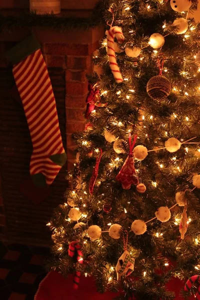 Een prachtig versierde kerstboom binnen met stralende lichtjes en in een gezellig huis — Stockfoto