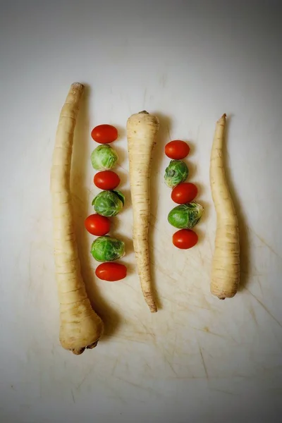 Вертикальный высокий угол съемки различных овощей на белой поверхности — стоковое фото