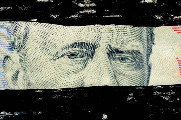 Closeup shot of the Ulysses s. grant face on the  dollar bill with black lines painted over it — 스톡 사진
