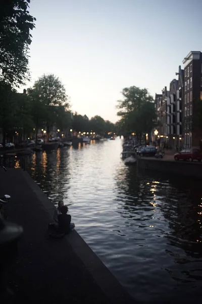 Vertikale Aufnahme des Kanals in Amsterdam bei Sonnenuntergang im Sommer — Stockfoto