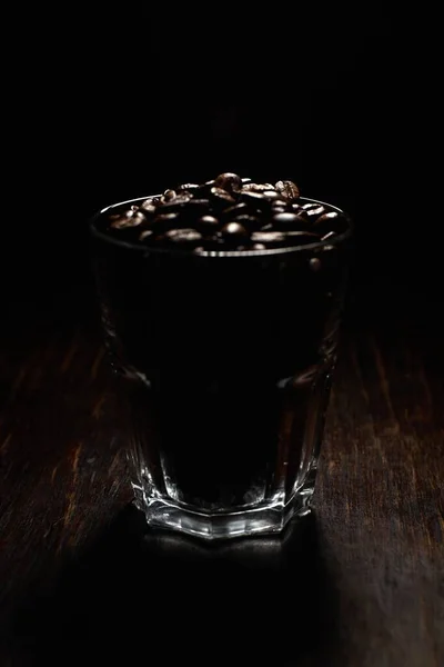 Vertical Shot Glass Cup Filled Coffee Beans Wooden Surface Black — ストック写真