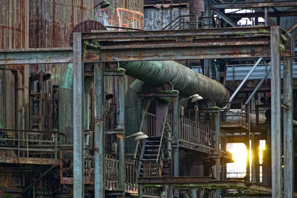 Metal merdivenleri ve boruları olan terk edilmiş eski bir fabrikanın güzel bir görüntüsü. — Stok fotoğraf