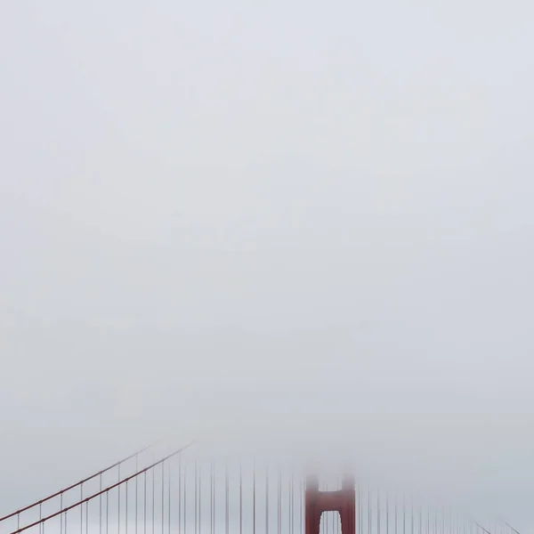 Golden Gate Bridge covered with fog in the early morning — стокове фото