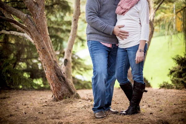 Shallow focus shot of a pregnant couple with his hand on the belly — Stock Photo, Image