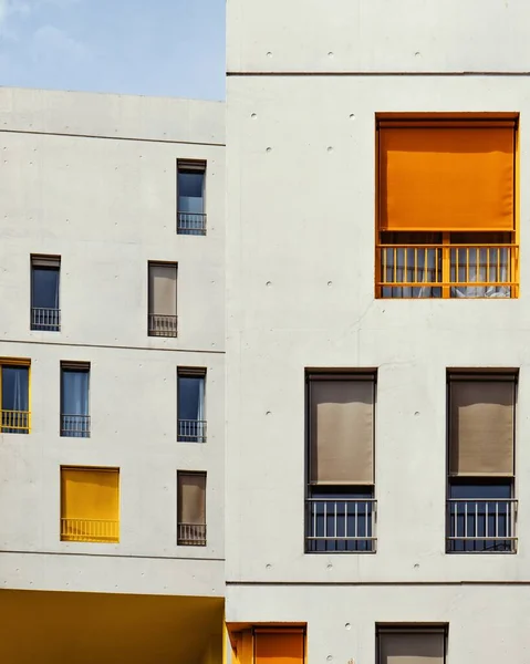Függőleges felvétel fehér épületekről színes függönyökkel az ablakokban — Stock Fotó