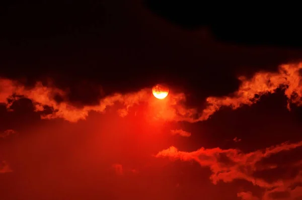 Vista deslumbrante do pôr do sol em um céu nublado vermelho — Fotografia de Stock