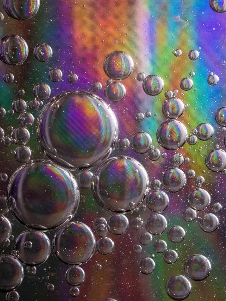 Vertical shot of soap bubbles on a colorful background with interesting textures — Stock Photo, Image