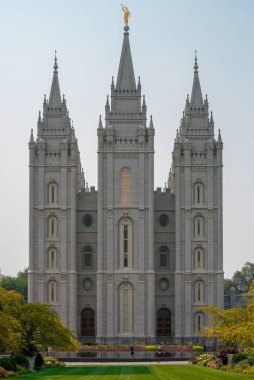 A vertical shot of the historic Salt Lake Temple touching the sky in the USA clipart