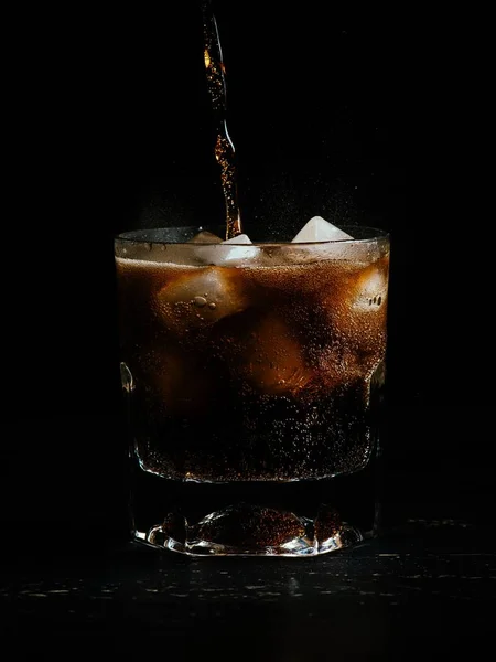 Vertical Shot Coke Being Poured Glass Full Ice Black Background — 스톡 사진