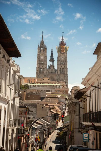 Basilica of the National Vow surrounded by buildings under a blue sky and sunlight in Ecuador — Stok fotoğraf