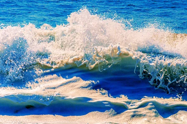 Piękne ujęcie uspokajających i rozpryskujących się fal oceanicznych w słoneczny dzień — Zdjęcie stockowe