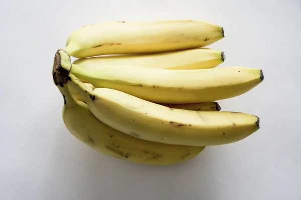 High angle shot of some bananas on a white surface — Stockfoto