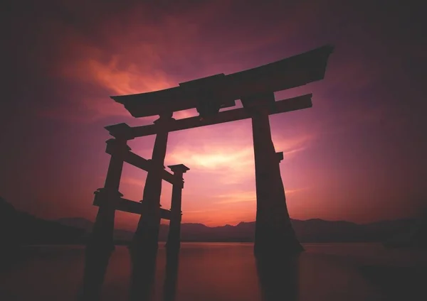 Pôr do sol de tirar o fôlego sobre os famosos torii flutuantes históricos de Miyajima, Japão — Fotografia de Stock