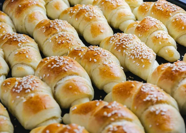 Closeup shot of delicious small croissants taken out from the oven - perfect for a food blog — Stock Photo, Image